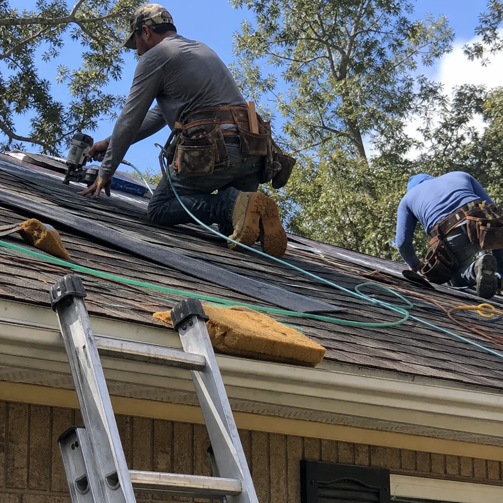 Professional roofers performing residential roof installation and repair services.
